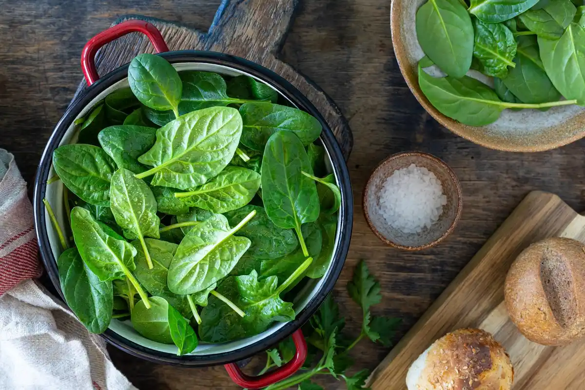 steaming fresh green vegetables in pot