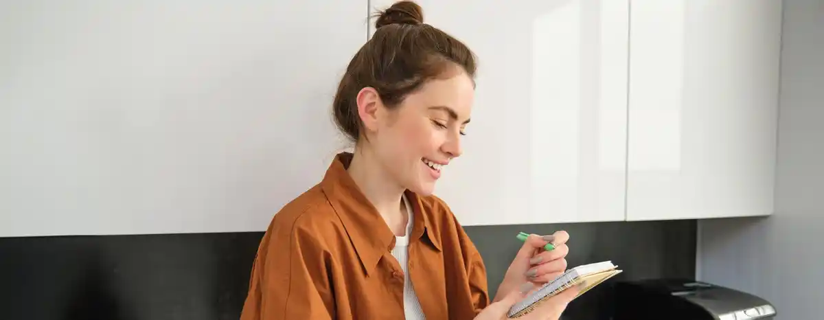 person managing time with smartphone and calendar